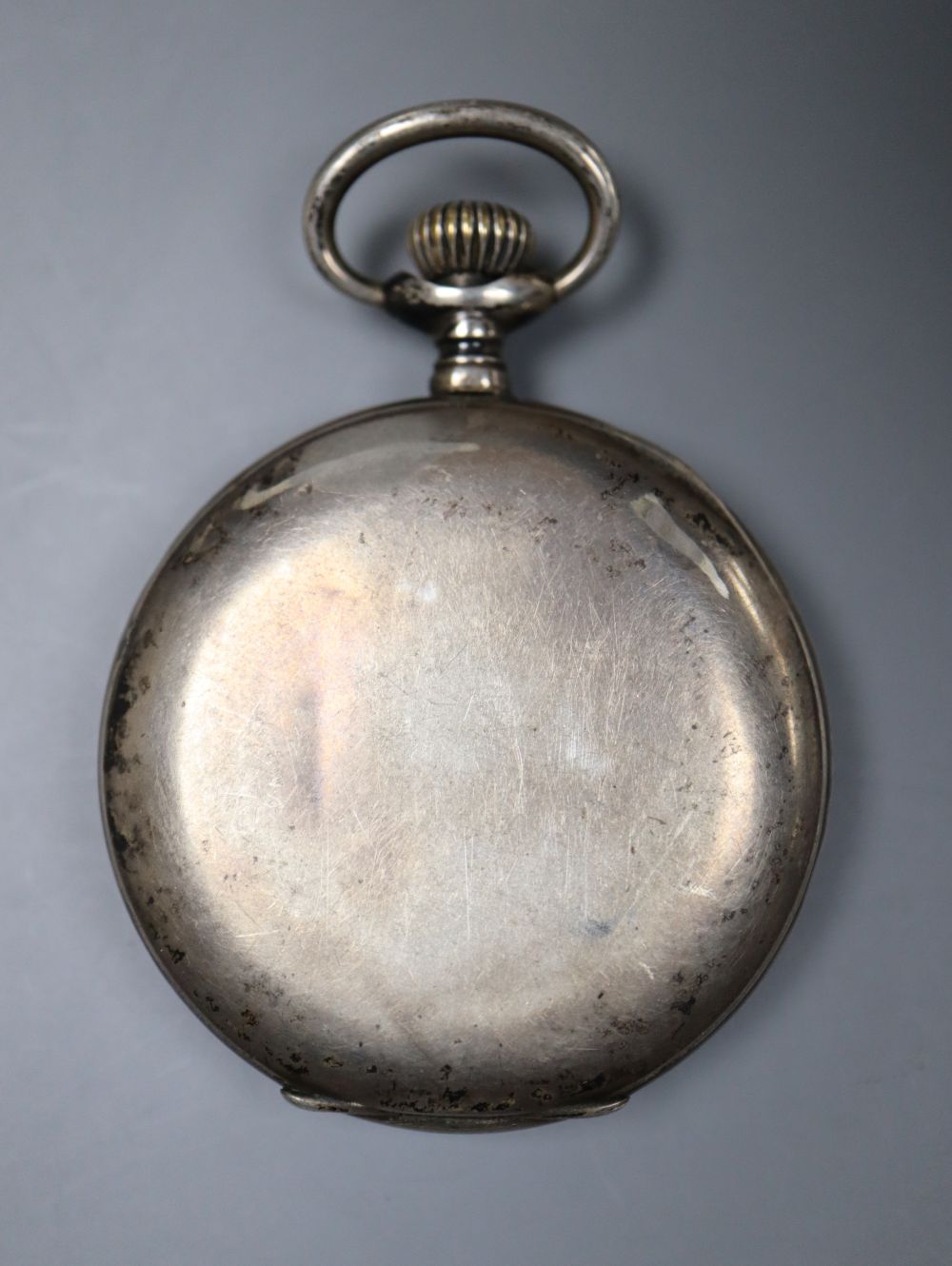 A white metal calendar moonphase keyless pocket watch.